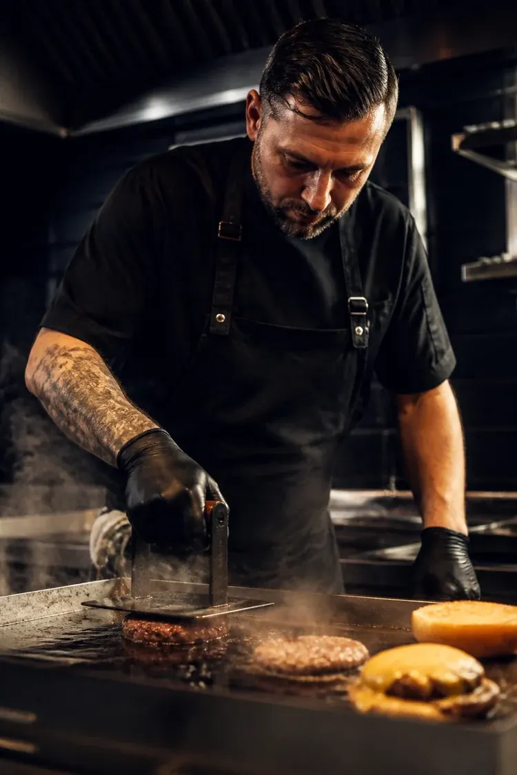 Chef preparing a fresh smashed burger
